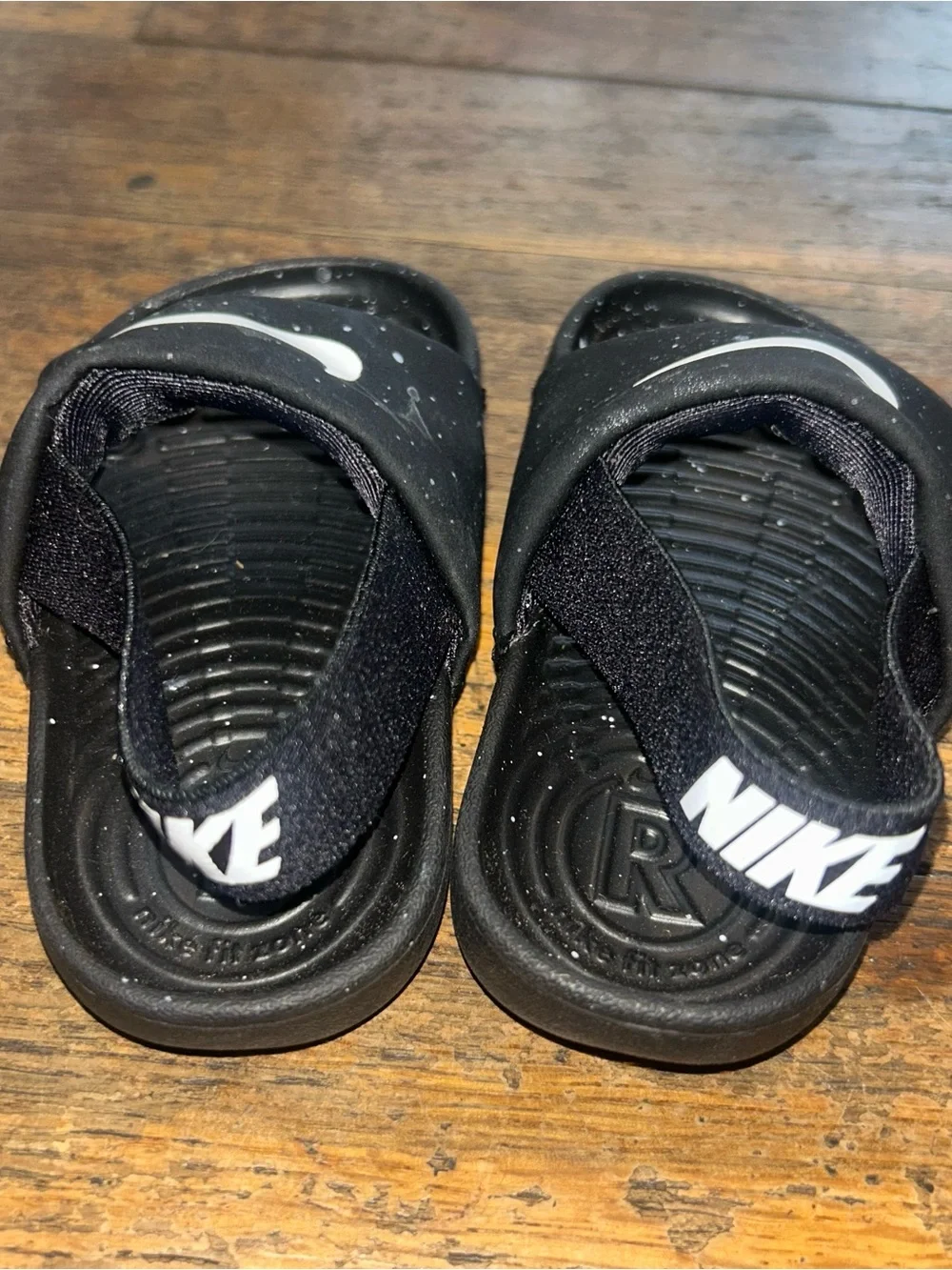 Nike Black Kids' Slide Sandals with White Swoosh and Paint-Splatter Detail
